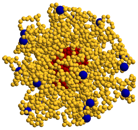 Three-dimensional molecular simulation of a dense, irregular polymer-like structure composed mainly of small yellow spheres, with larger blue particles distributed throughout and a cluster of red particles near the center.
